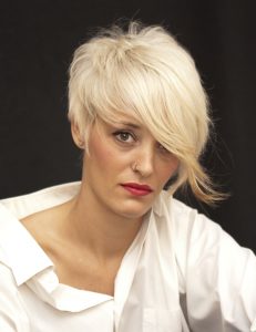 Beautiful woman with white man's shirt and short white hair on black background